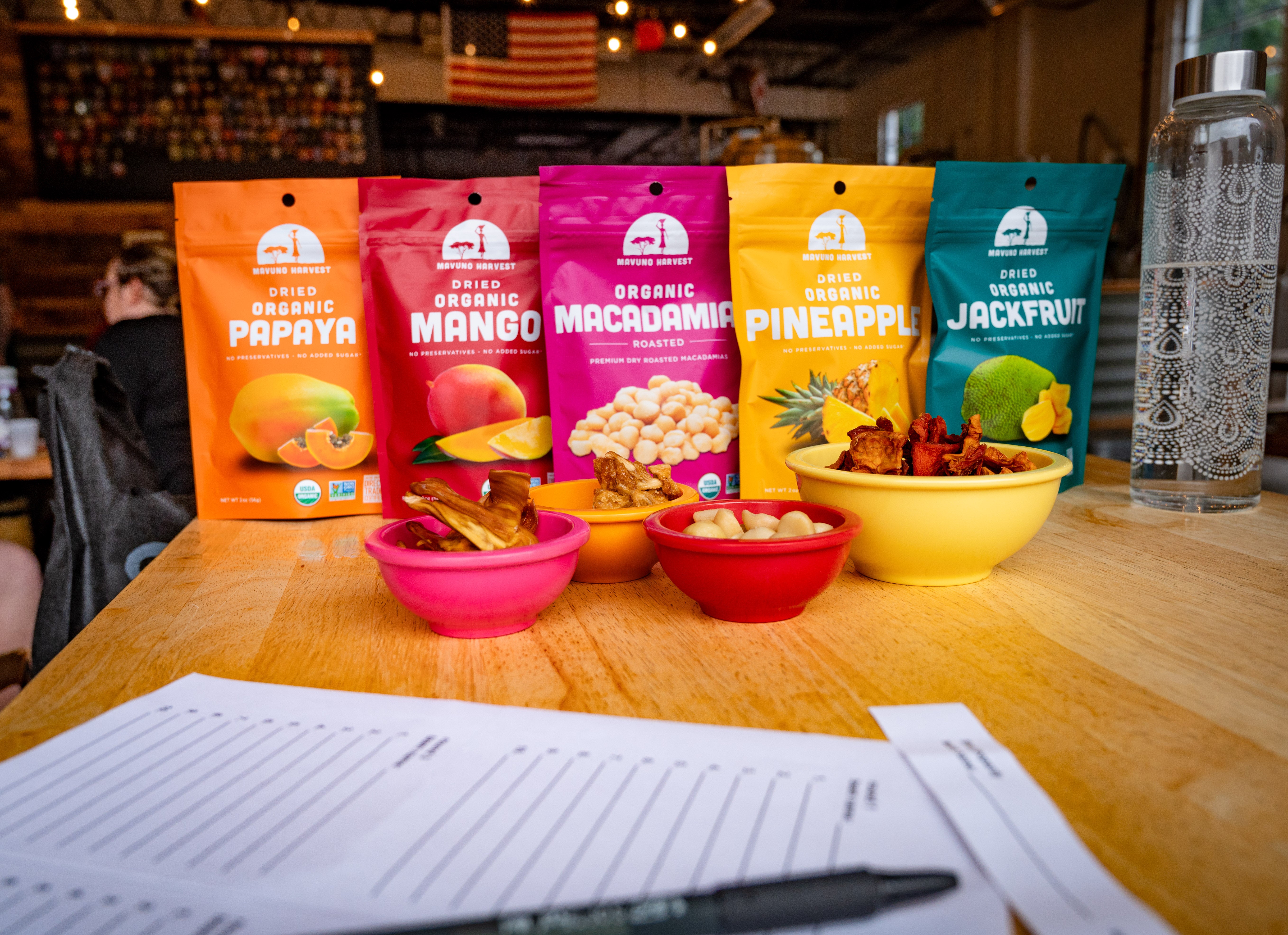 Mavuno dried fruit pouches and snacks arranged on a table