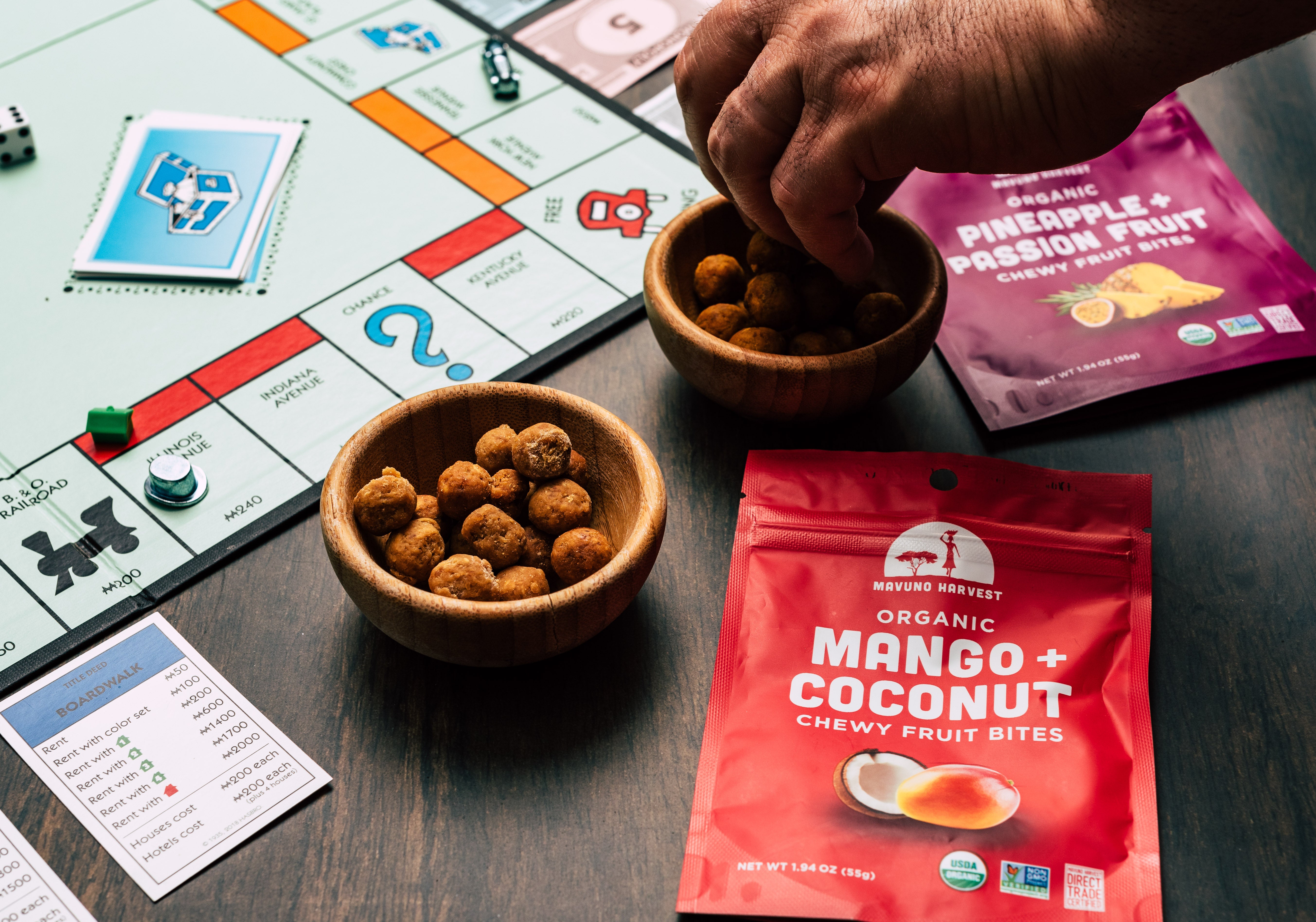 Mavuno fruit bites pouches and snack bowls on a board-game table